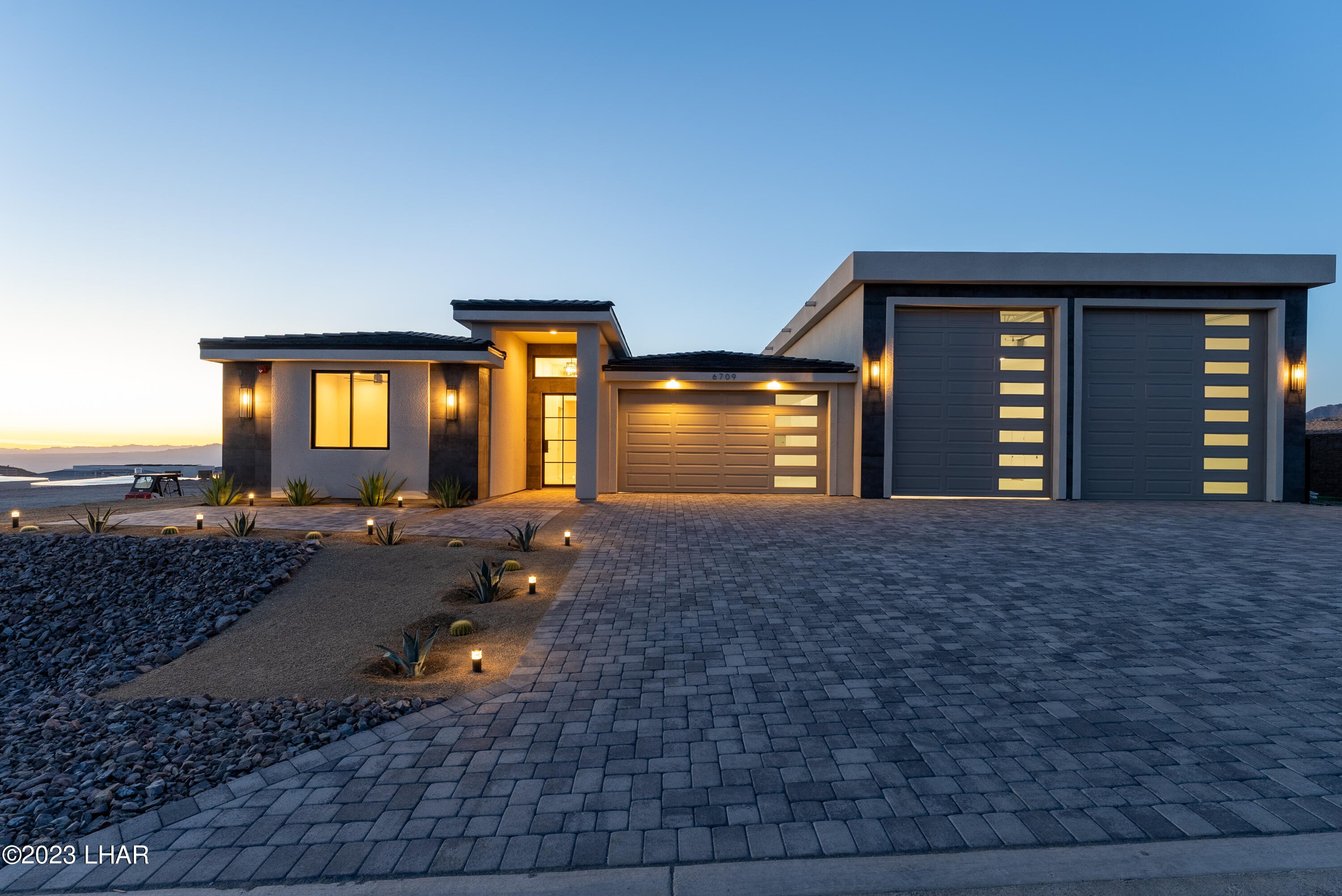 Modern Lake Havasu City home with two tall motorhome garage doors