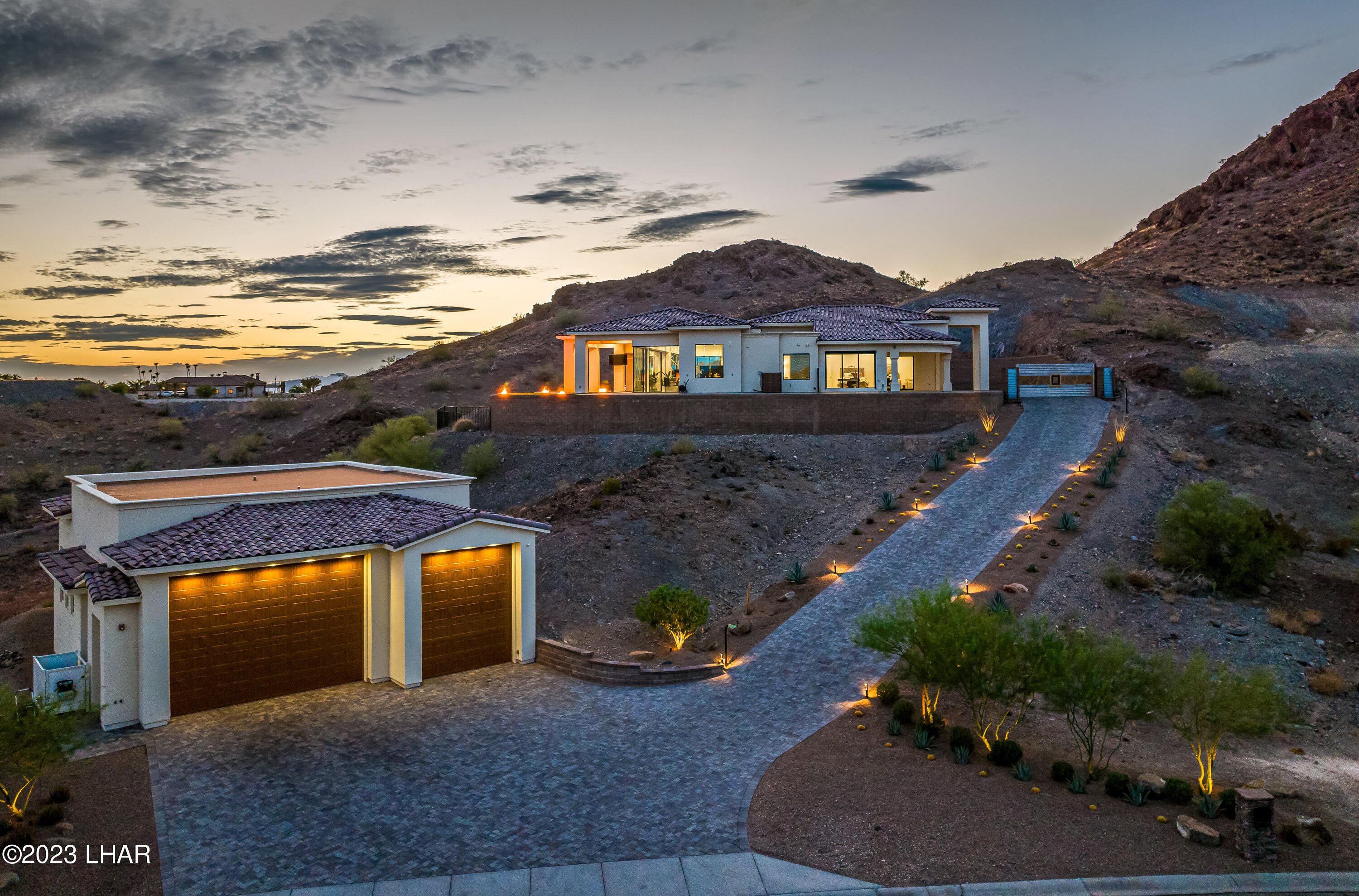 Lake Havasu hillside property with a detached multi-bay garage and long driveway